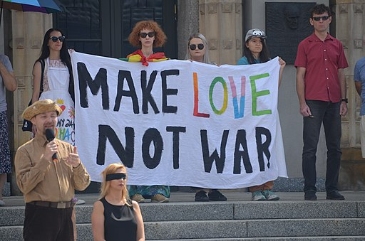 Hippies with Make Love Not War sign