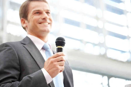 Businessman speaking with microphone