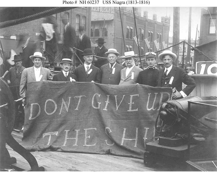 Historic photo of sailors showing banner, "Don't Give Up The Ship."