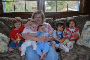 grandmother trying to hold five small grandkids on her lap.