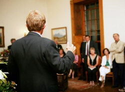 View from behind a man giving a special tribute at a social function.