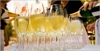 Table of toasting glasses filled with Champaigne.