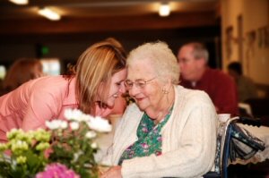 Grandma getting hug and flowers