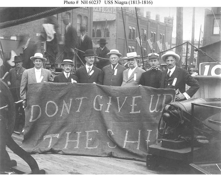 Historic photo of sailors showing banner, "Don't Give Up The Ship."